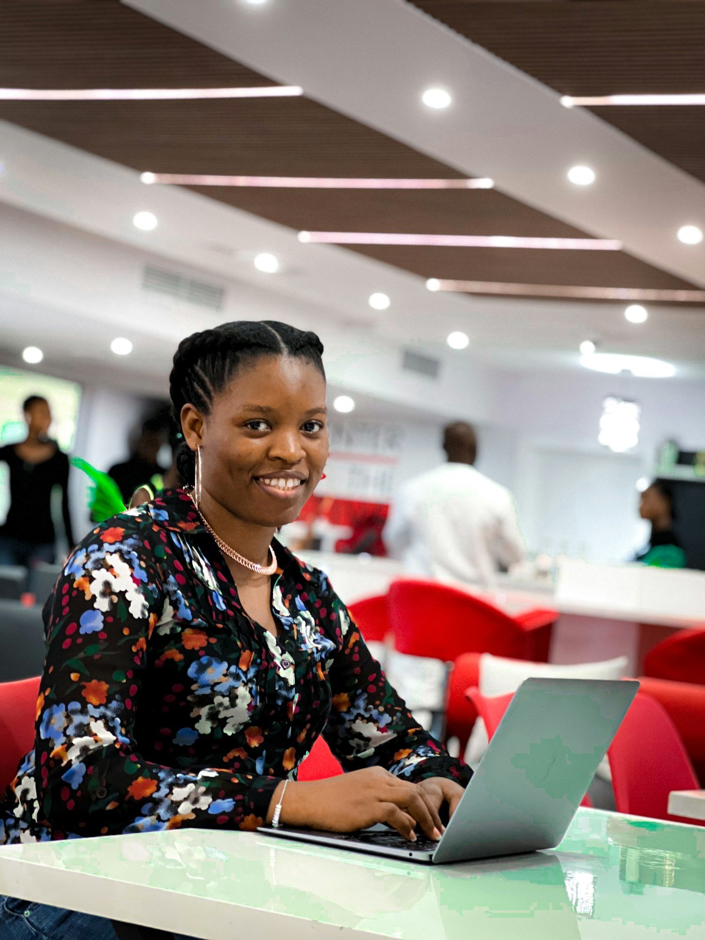 A young African professional smiling at a co-working hub